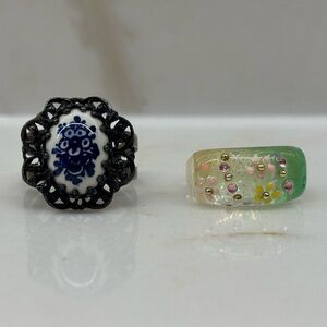Pair of Floral Rings One With Delft Style Centre and One Handmade Resin